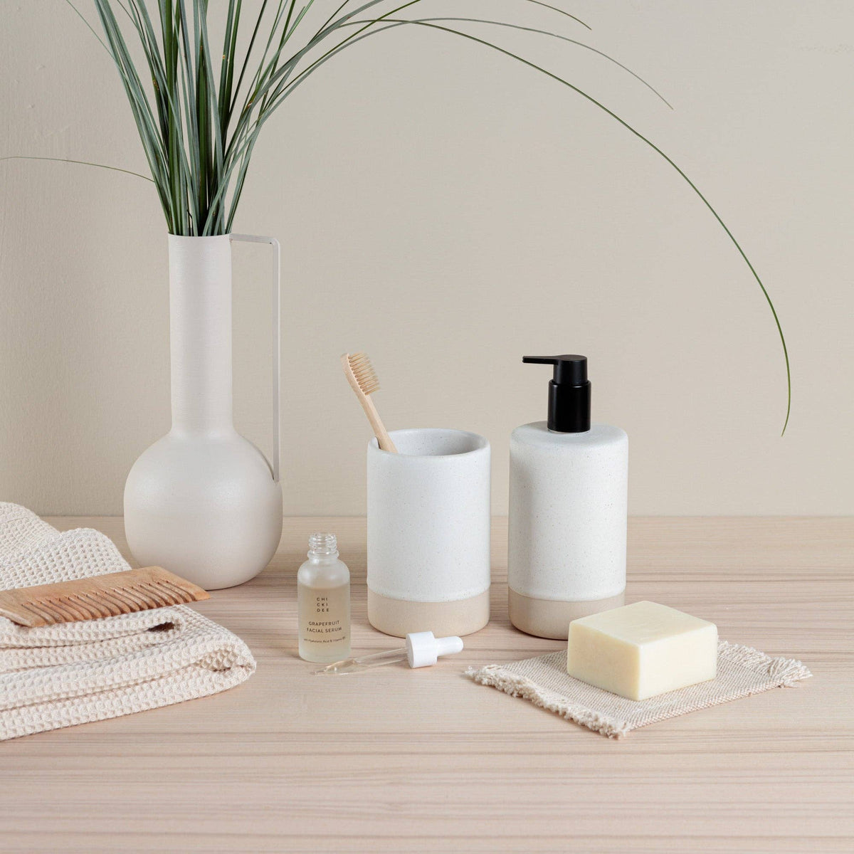 Oatmeal ceramic soap dispenser styled on a spa vanity