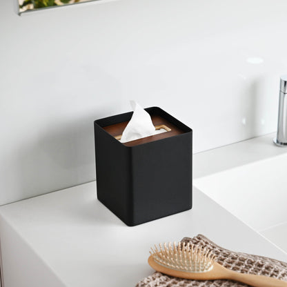 Side view of black Tissue Case on bathroom sink countertop by Yamazaki Home.