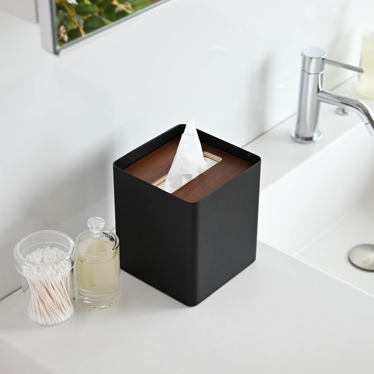 Aerial view of black Tissue Case on bathroom sink countertop by Yamazaki Home.
