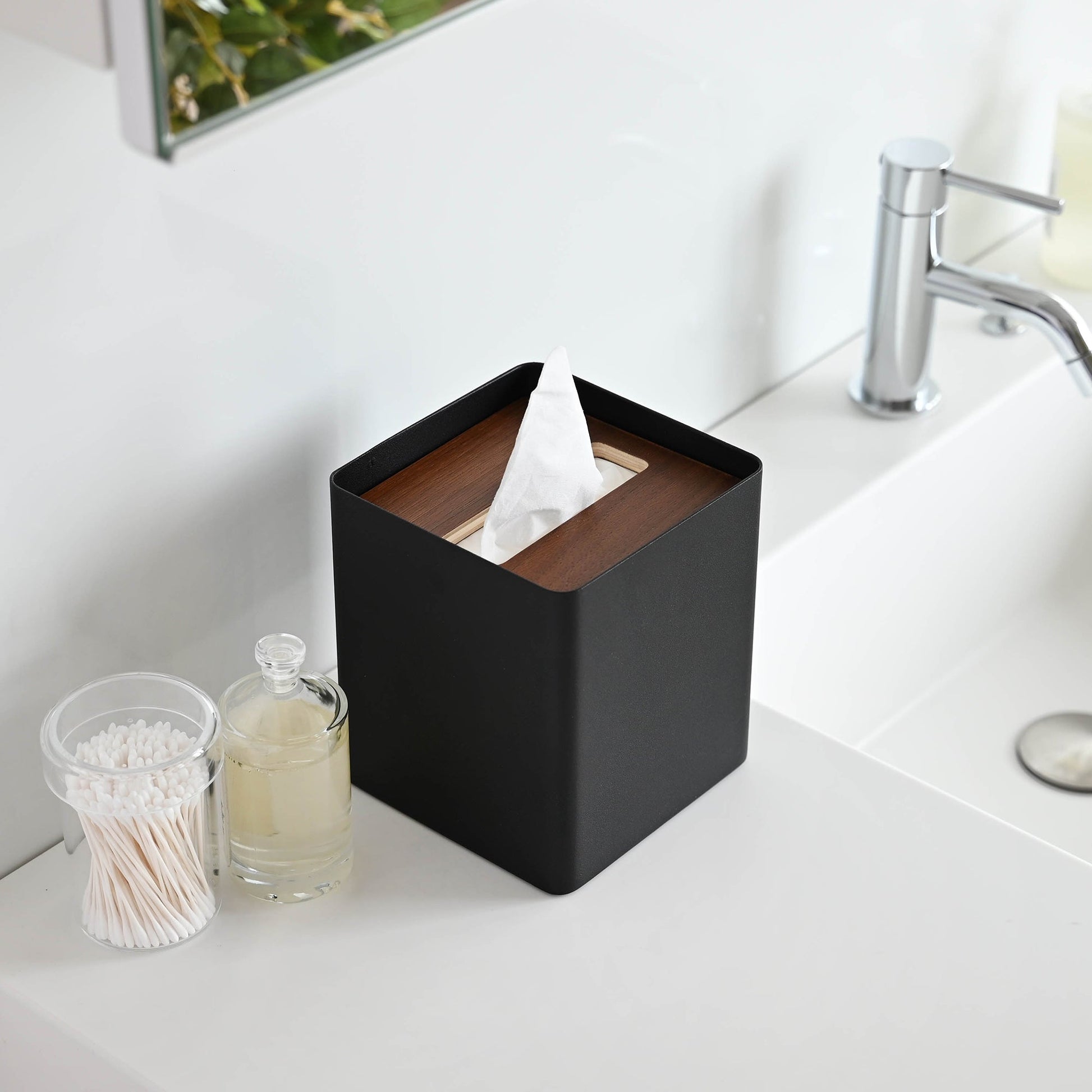 Aerial view of black Tissue Case on bathroom sink countertop by Yamazaki Home.