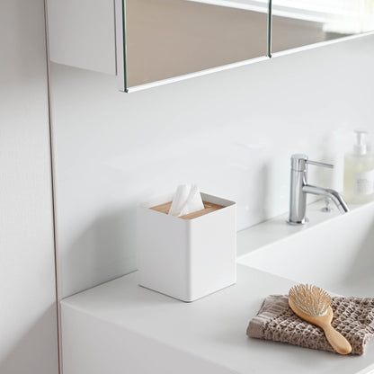 Side view of white Tissue Case on bathroom sink countertop by Yamazaki Home.