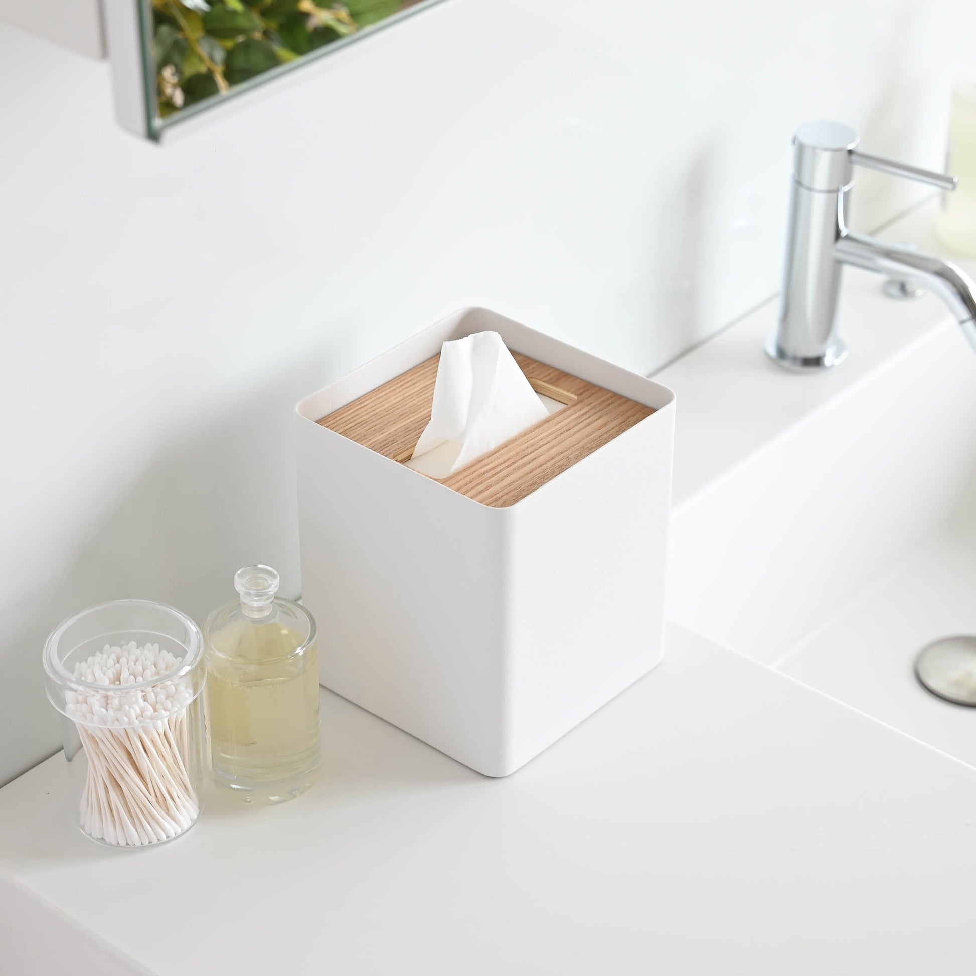 Aerial view of white Tissue Case on bathroom sink countertop by Yamazaki Home.