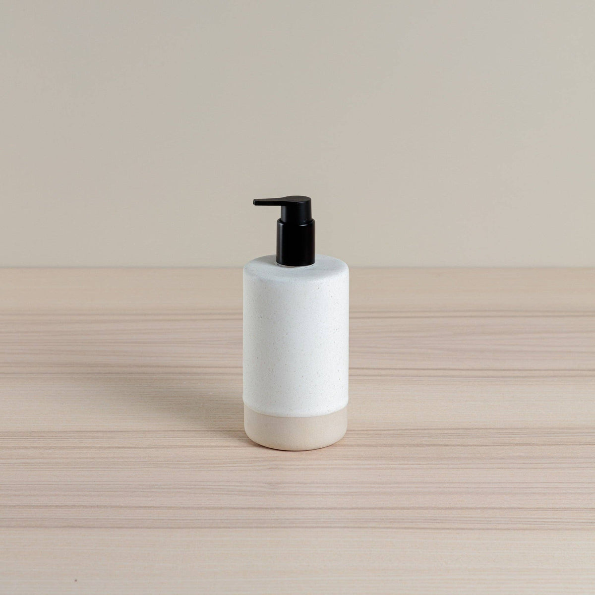 Ceramic soap dispenser in oatmeal glaze with black pump