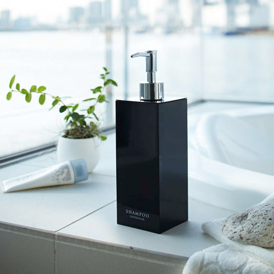 Black Yamazaki Home square shampoo dispenser by bathtub