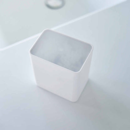 Top view of the cotton swab push-top case with the lid on from Yamazaki Home in white.