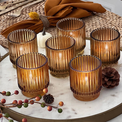 Amber ribbed glass votive holders grouped as a table centerpiece