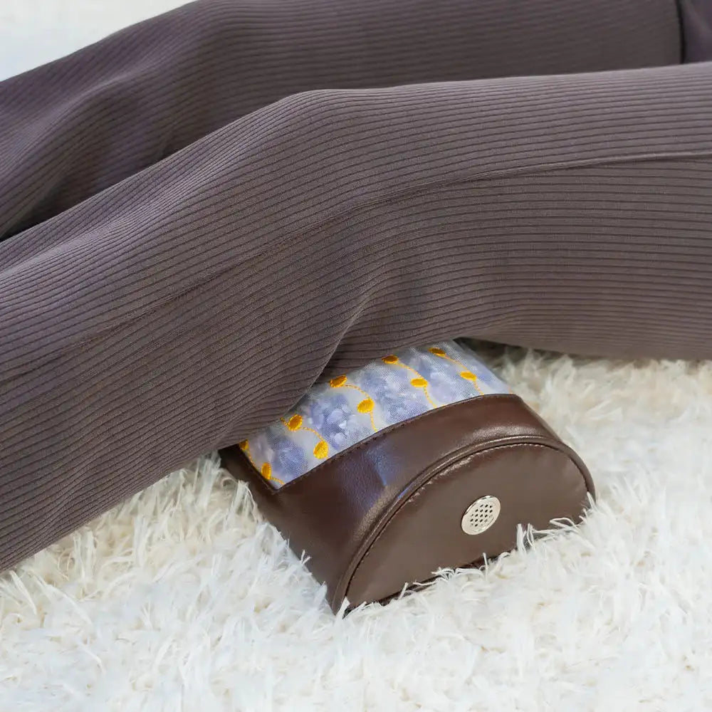 Heated amethyst bolster providing knee support for relaxation