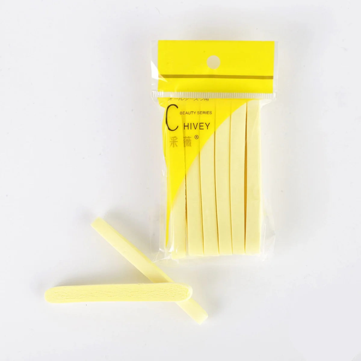 12-pack compressed cellulose facial sponges in yellow packaging with two loose sponges showing porous texture