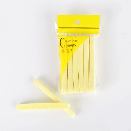 12-pack compressed cellulose facial sponges in yellow packaging with two loose sponges showing porous texture