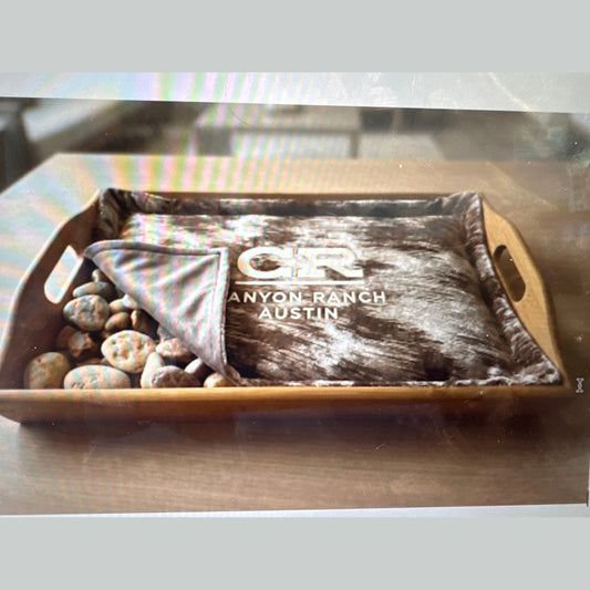 Custom brown massage warming tray coverlet with Canyon Ranch Austin embroidery in wooden tray