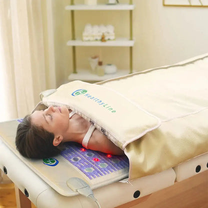 Spa treatment scene with woman on HealthyLine Taj mat featuring illuminated red light therapy