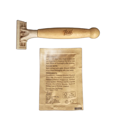 Tess bamboo-handled pivot head razor beside the back of the shave cream packet with directions and ingredients