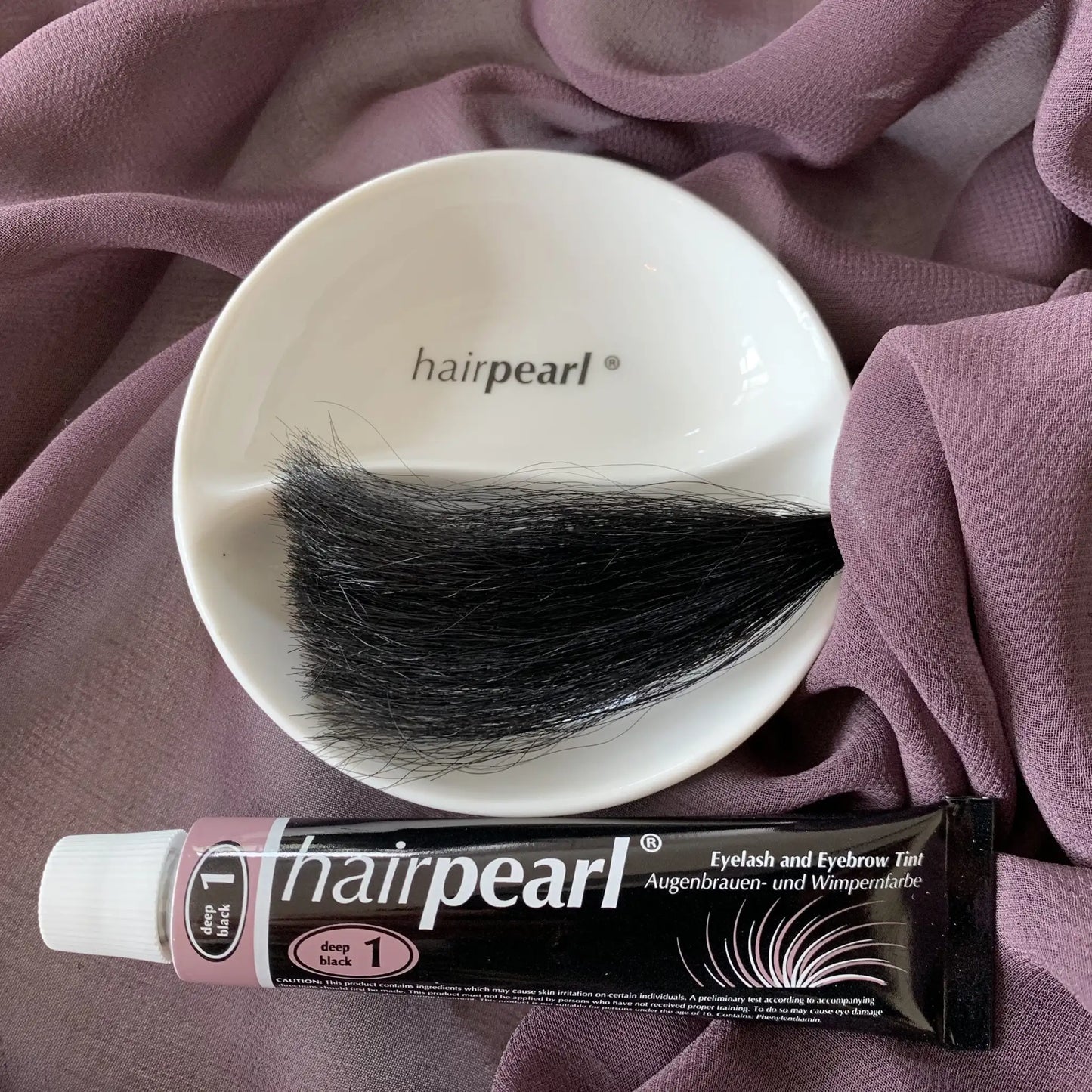 Hairpearl deep black eyelash tint on dark hair strands showing rich definition result