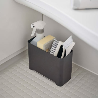 Black Yamazaki Self-Draining Bathroom Organizer filled with cleaning supplies