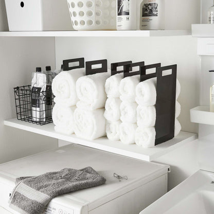 Black Towel Storage Organziers holding towels on laundry room shelf by Yamazaki Home.