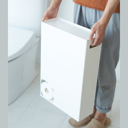 Front view of white Toilet Paper Stocker carried by handles in bathroom by Yamazaki Home.