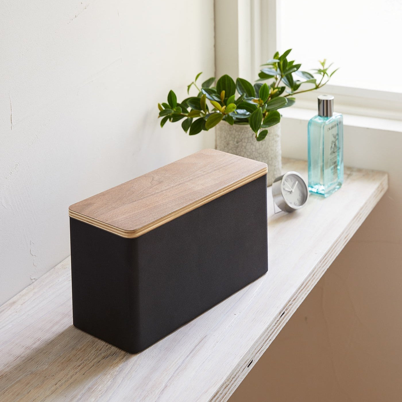 Front view of black Countertop Organizer on shelf by Yamazaki Home.