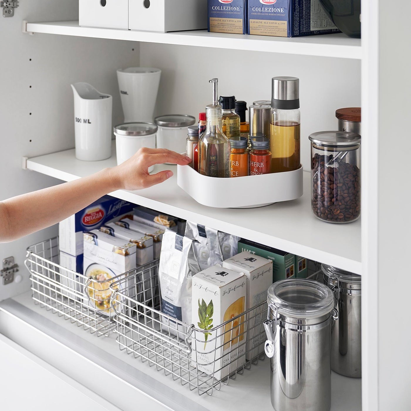 White Yamazaki Home Rotating Storage Tray with spices and oil stored being turned
