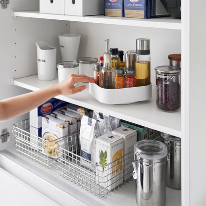 White Yamazaki Home Rotating Storage Tray with spices and oil stored being turned