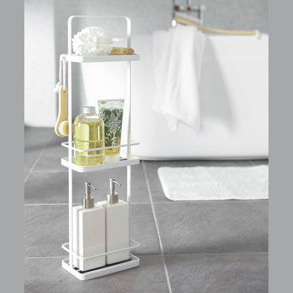 White Portable Shower Caddy displaying cleaning products in bathroom by Yamazaki Home.