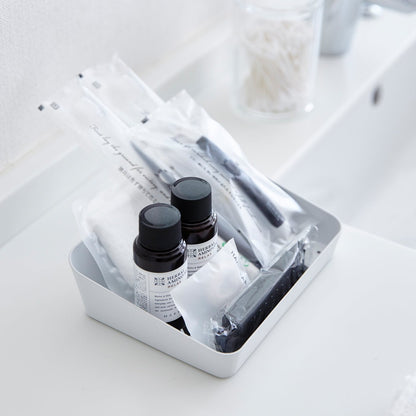 Aerial view of white Accessory Tray holding beauty products on bathroom sink counter by Yamazaki Home.