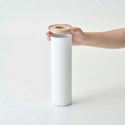 Top of small white Yamazaki Home Round Tissue Case being removed