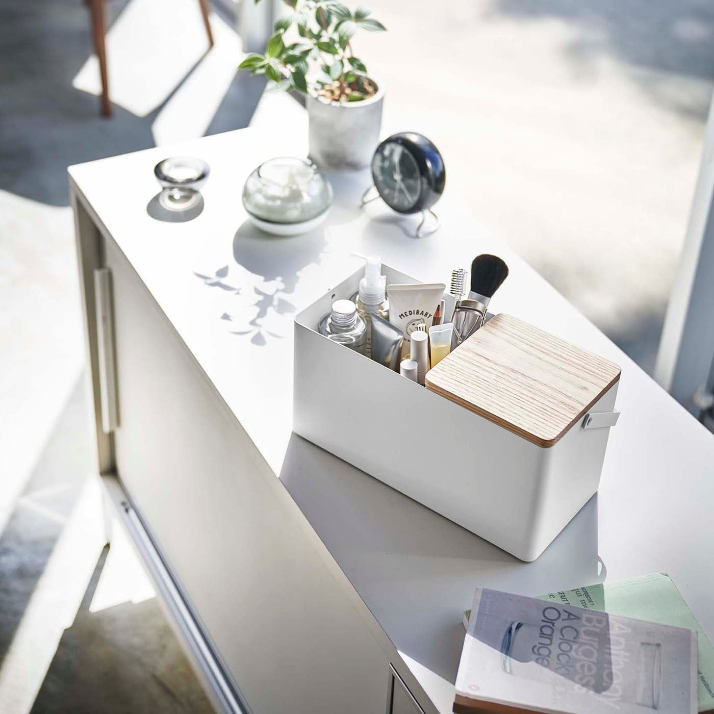Closed white Makeup Organizer holding makeup on countertop by Yamazaki Home.