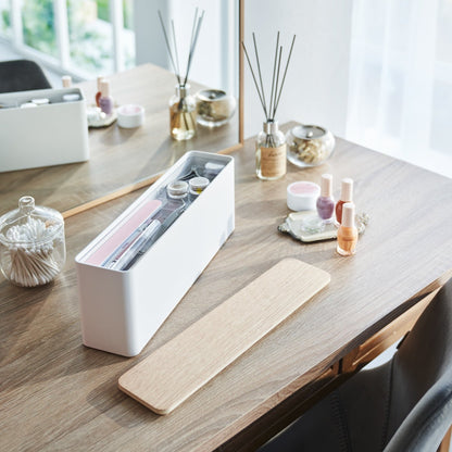 An open Yamazaki Nail Polish Organizer holding various nail accessories on a table.