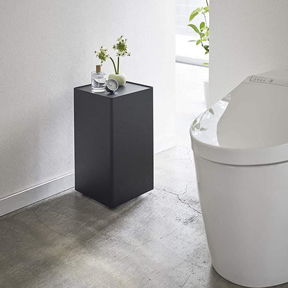 Black Rolling Bathroom Organizer with dÃÂ©cor on top in bathroom by Yamazaki Home.