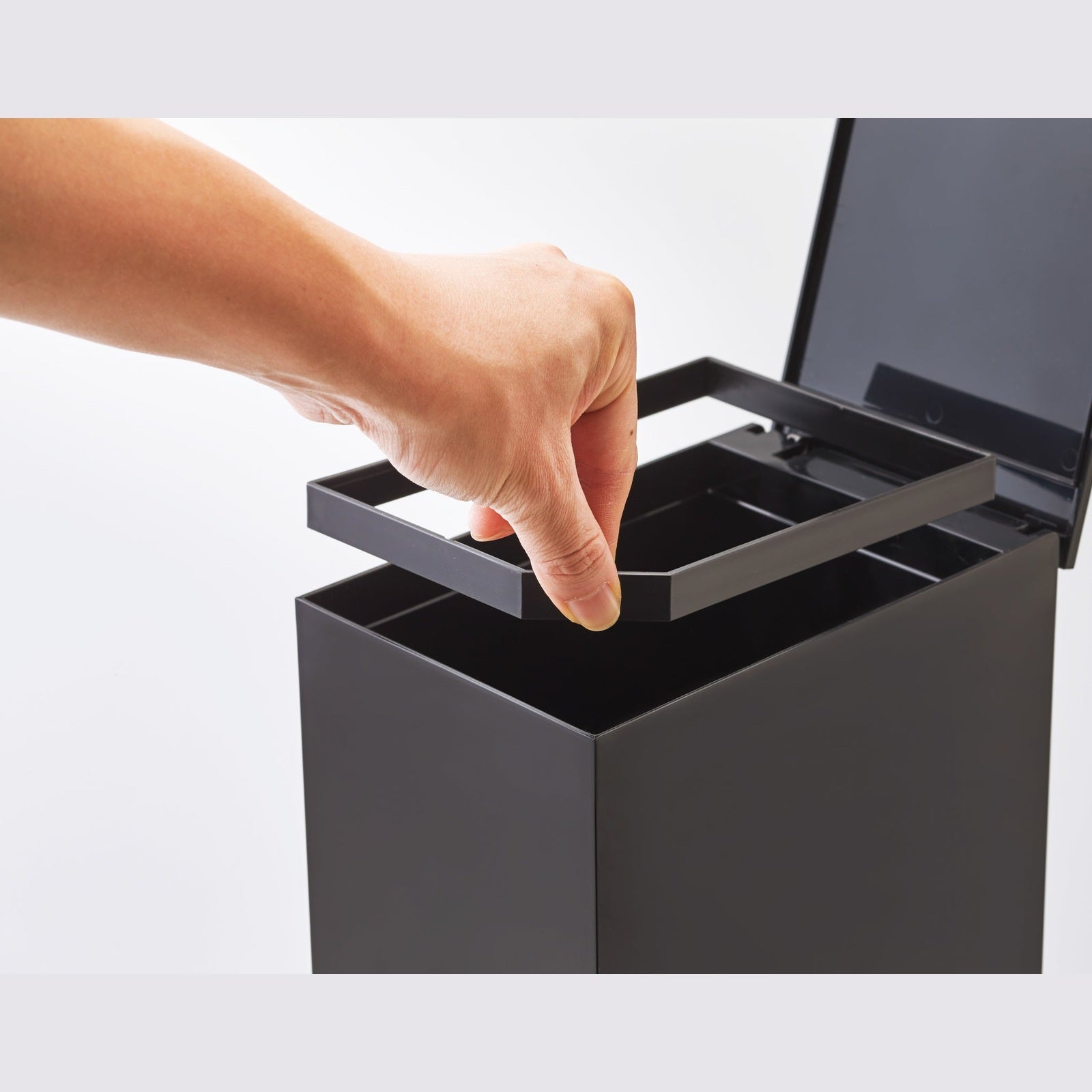 Black Step Trash Can open with top insert frame on white background by Yamazaki Home.
