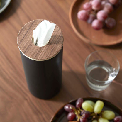 Close up of Large black Yamazaki Home Round Tissue Case on a dining table