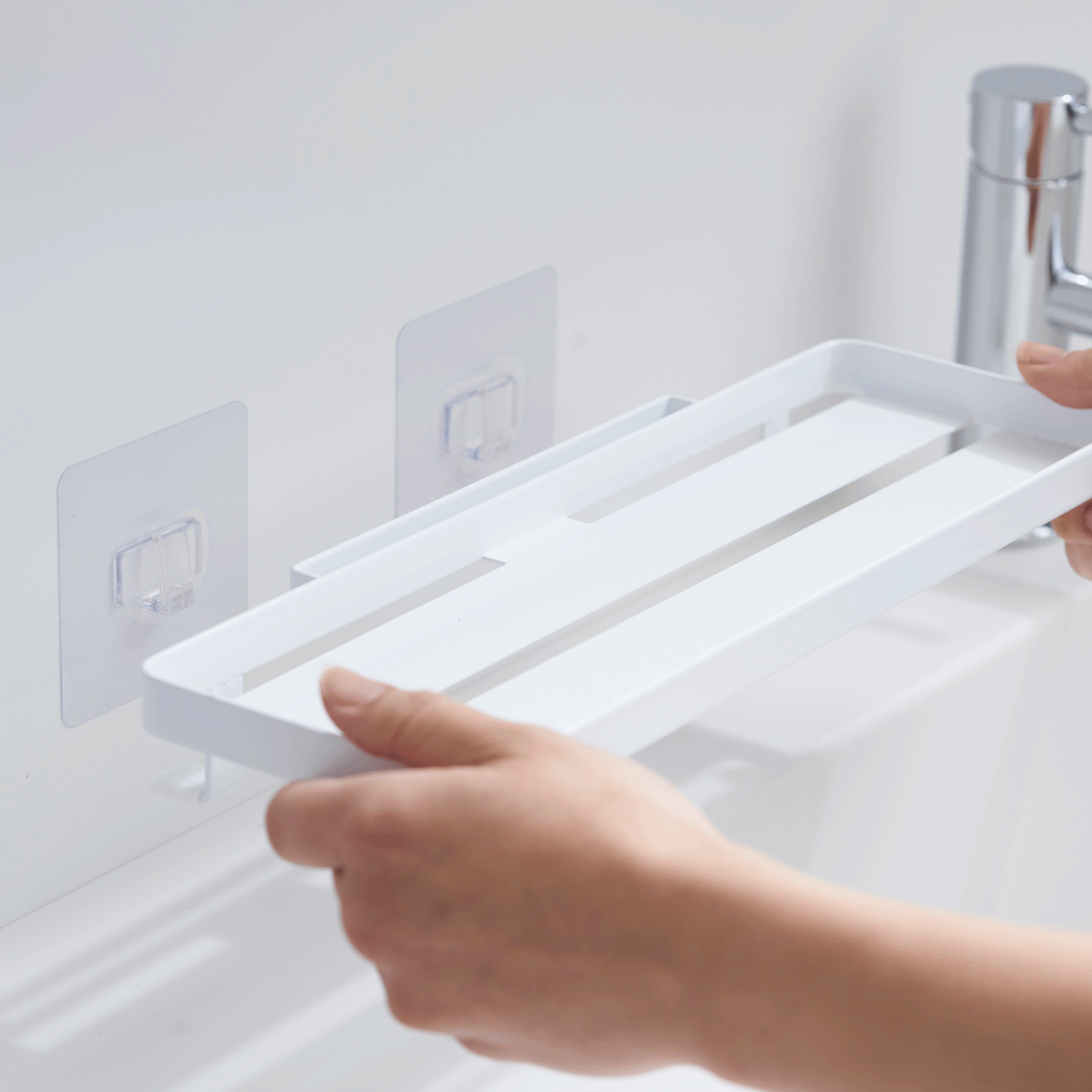 GIF of placing Yamazaki Home Traceless Adhesive Floating Tray on hooks attached to wall