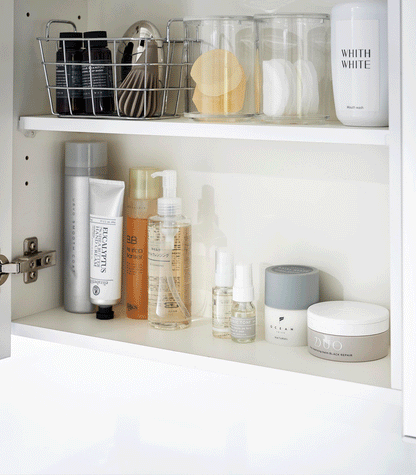 Product GIF showing Medicine Cabinet Riser [Set of 2] with various props.