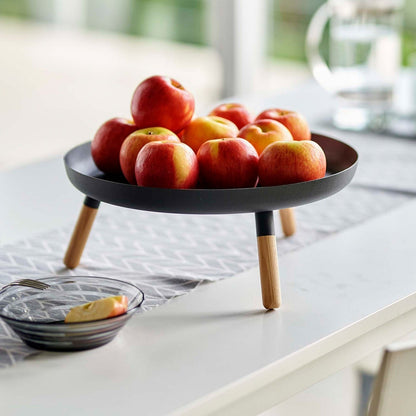 Black Yamazaki Countertop Pedestal Tray with apples on top on a dining table