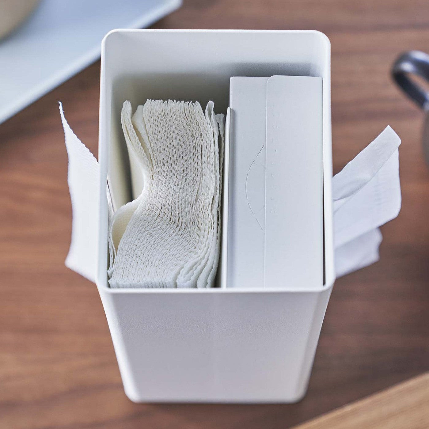 Close up top-down view of opened white Yamazaki Two-Sided Tissue Case on a table