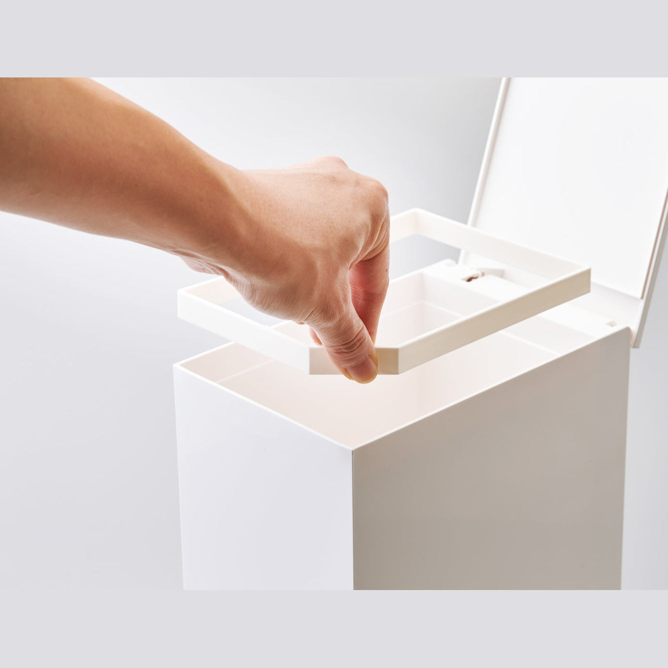 White Step Trash Can open with top frame insert piece on white background by Yamazaki Home.