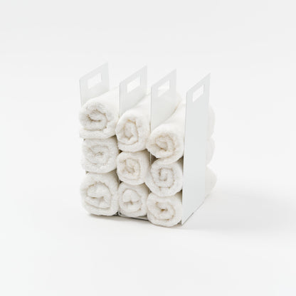 Yamazaki Home Towel Storage Organizer with props, set against a white background.