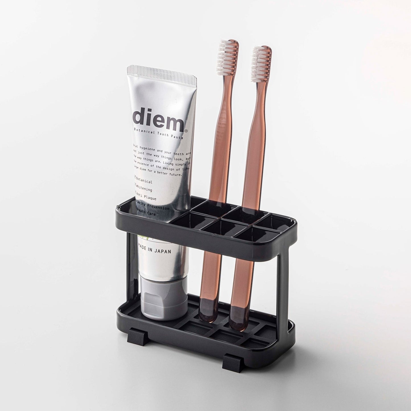 Prop photo showing Toothbrush + Toothpaste Stand with various props.