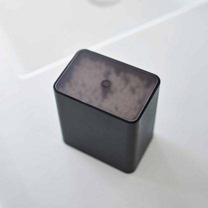 Top view of the cotton swab push-top case with the lid on from Yamazaki Home in black.