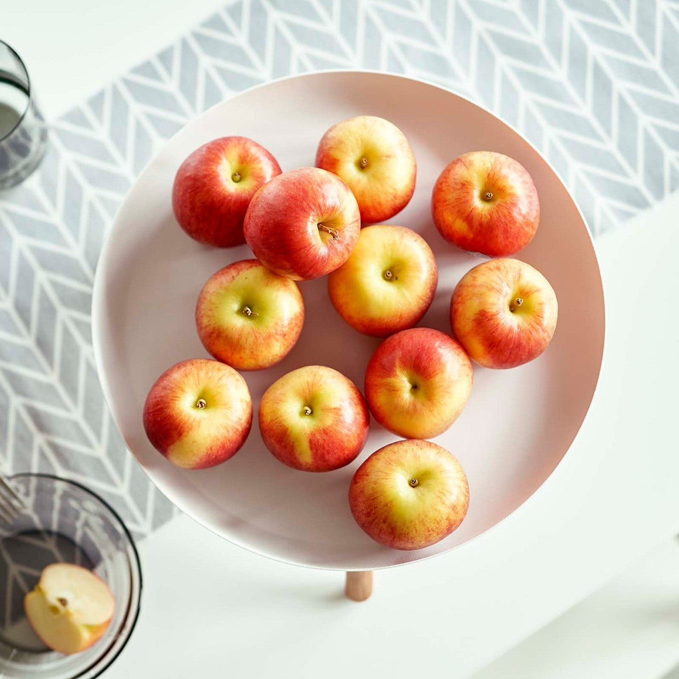 Top-down view of white Yamazaki Countertop Pedestal Tray with apples on top