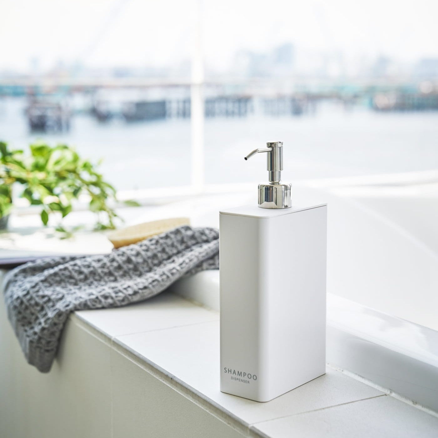 White Shampoo Dispenser in bathroom by Yamazaki Home.
