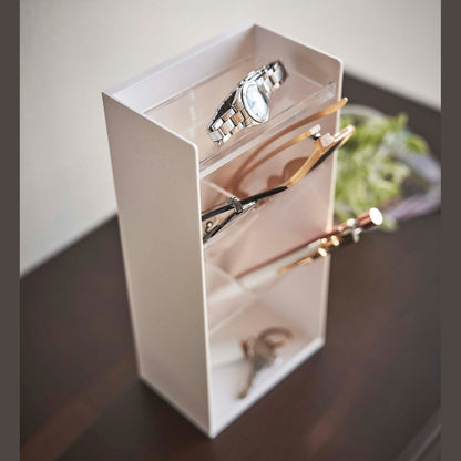 Close up of white Yamazaki Home Accessory Organizer holding accessories such as pens and sunglasses