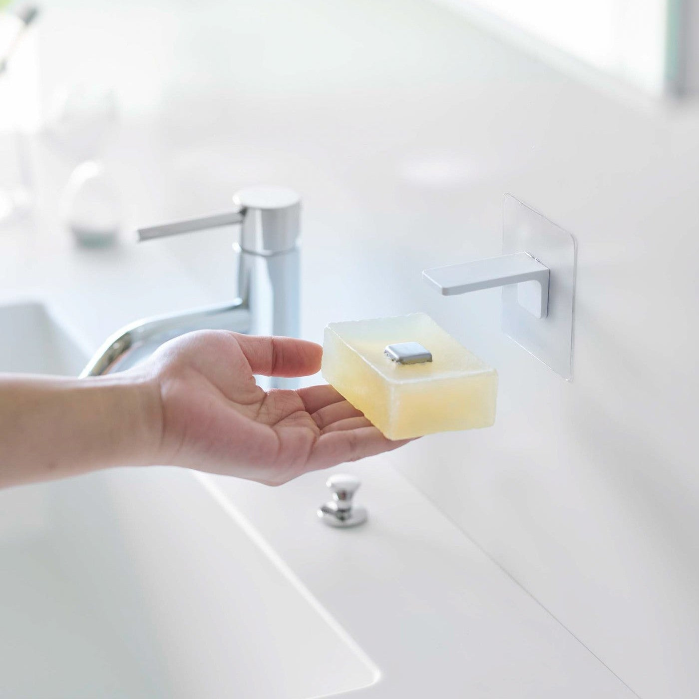 Taking out soap from white Yamazaki Home Magnetic Soap Holder