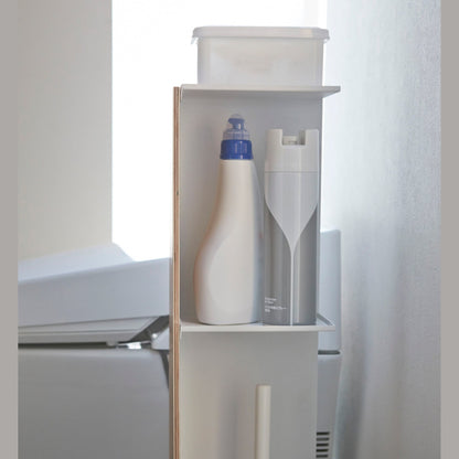 Side view of Toilet Paper Stocker holding bathroom cleaning items and accessories in bathroom by Yamazaki Home.