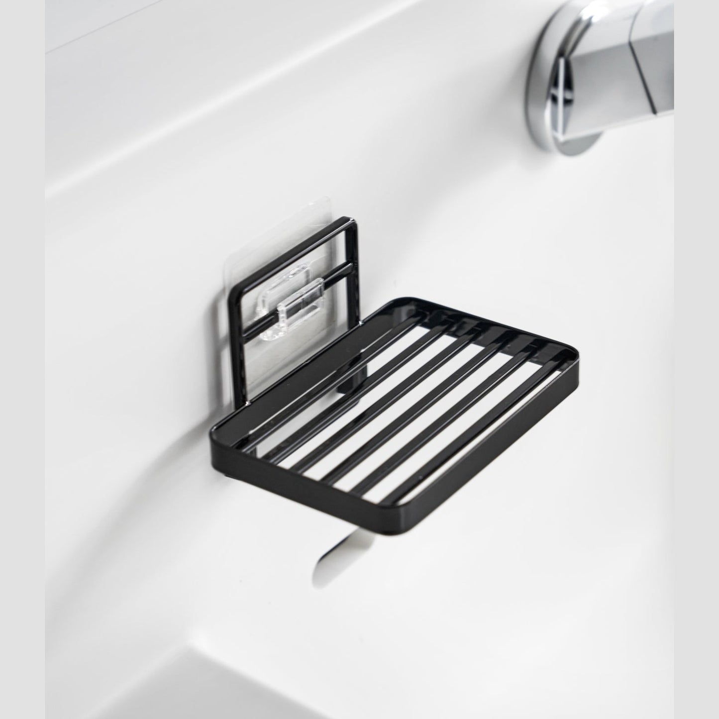 Yamazaki Home's black Traceless Adhesive Soap Tray mounted on a bathroom wall.