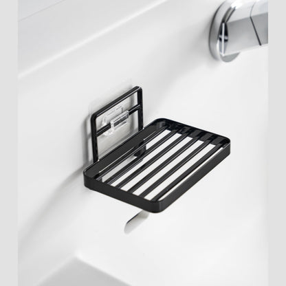 Yamazaki Home's black Traceless Adhesive Soap Tray mounted on a bathroom wall.