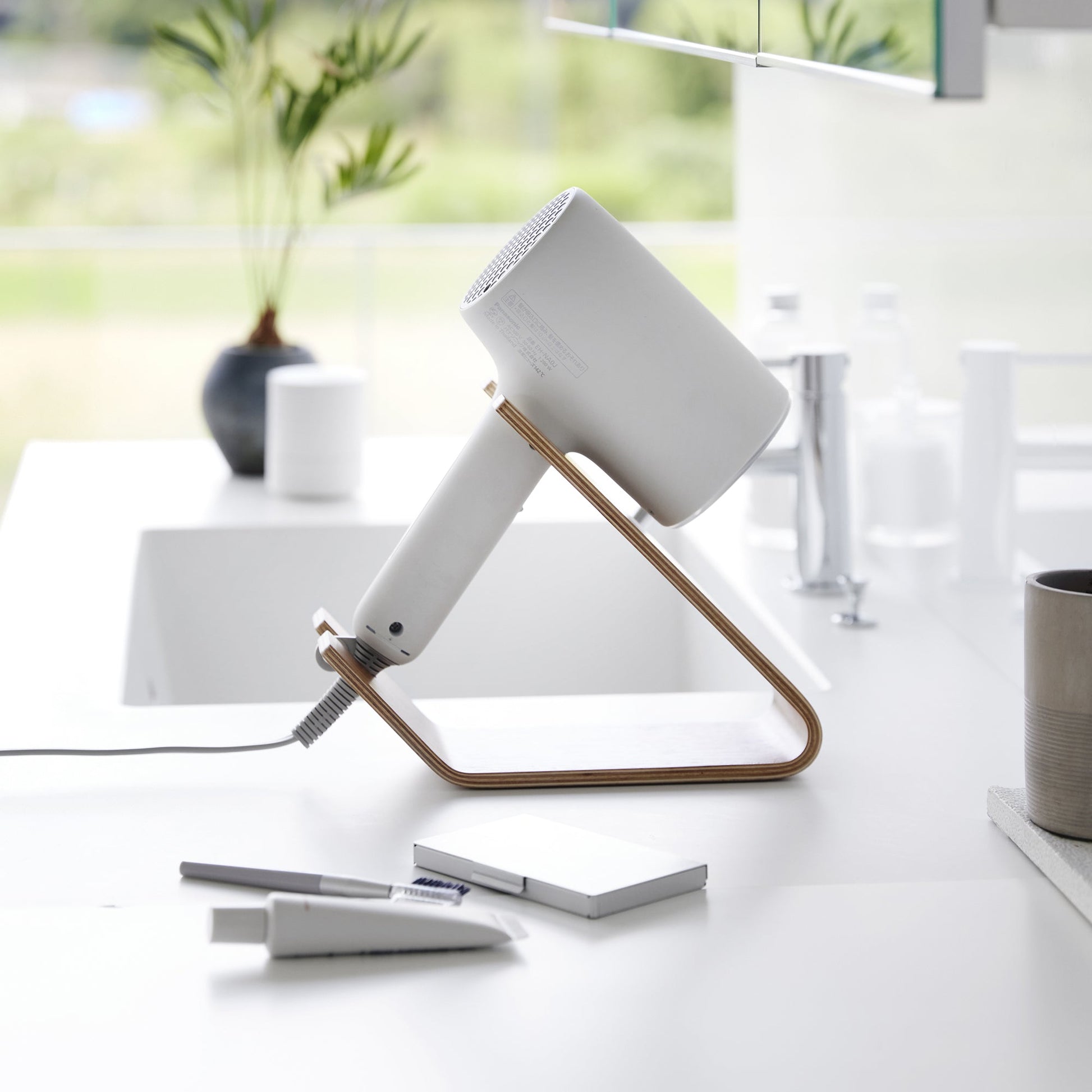 Side view of ash Yamazaki Home Hair Dryer and Iron Stand storing a hair dryer
