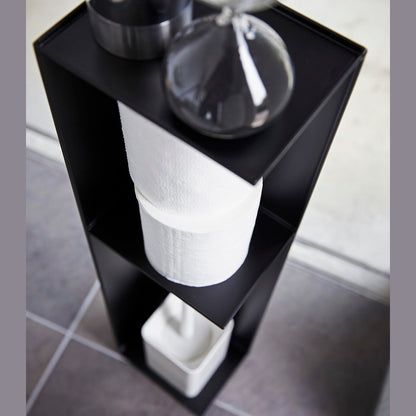 Yamazaki Home black Toilet Organizer holding decor pieces, toilet paper, and toilet brush.