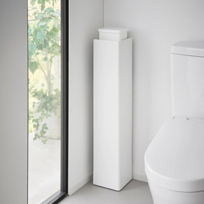 White Yamazaki Home Rolling Bathroom Organizer turned around to conceal the toilet brush and other items stored