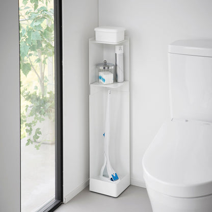 White Yamazaki Home Rolling Bathroom Organizer next to a toilet storing a toilet brush, cleaning spray and wet wipes